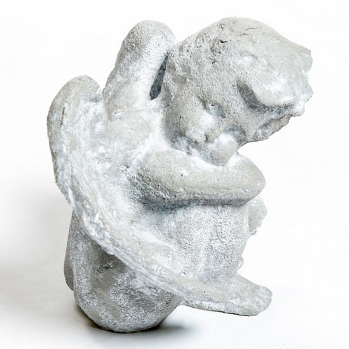 Seated cherub figurine with hands resting and large wings.