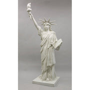 Statue of Liberty replica with classical draped robe, ornate crown, and raised torch in neoclassical architectural style. Different Angle
