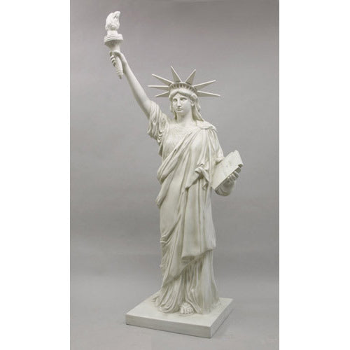 Statue of Liberty replica with classical draped robe, ornate crown, and raised torch in neoclassical architectural style. Different Angle