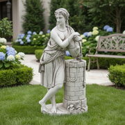 Classical European statue of a woman in draped attire leaning on a stone well with ornate, Renaissance-inspired detailing. Side Angle