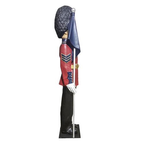 British royal guard statue in ornate old world European style uniform, tall bearskin hat, holding a flag, classical military theme Additional Angle