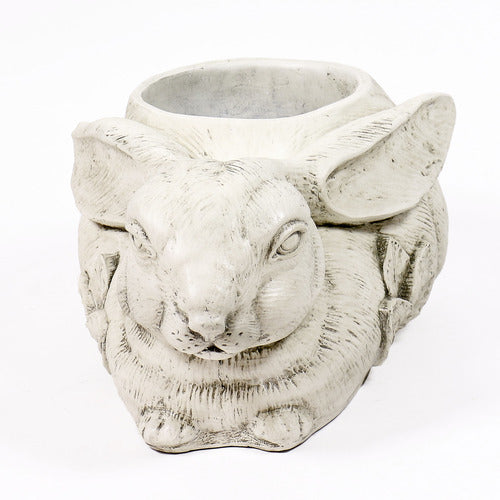 Rabbit-shaped planter with ornate floral motif, featuring old world European style and filled with yellow and orange flowers. Side View