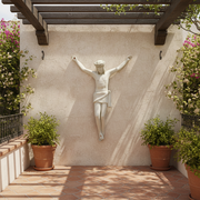 Crucifix sculpture featuring Jesus with outstretched arms, classical old world European style, detailed and ornate design. Side Angle