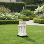 Greek temple miniature with fluted columns, classical pediment, and stepped base in old world European architectural style. Side Angle