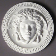 Medusa head relief with flowing serpentine hair, surrounded by a Greek key border in classical old world European style. Side View