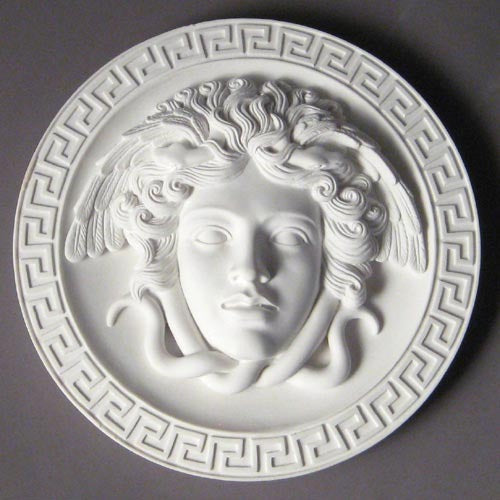 Medusa head relief with flowing serpentine hair, surrounded by a Greek key border in classical old world European style. Side View