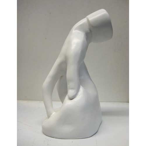 Classical Renaissance-style torso sculpture with detailed musculature and an unfinished, headless form on a smooth base. Side View