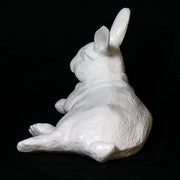 Reclining rabbit sculpture with classical old world European style and subtle ornate detailing in a lifelike pose. Side View