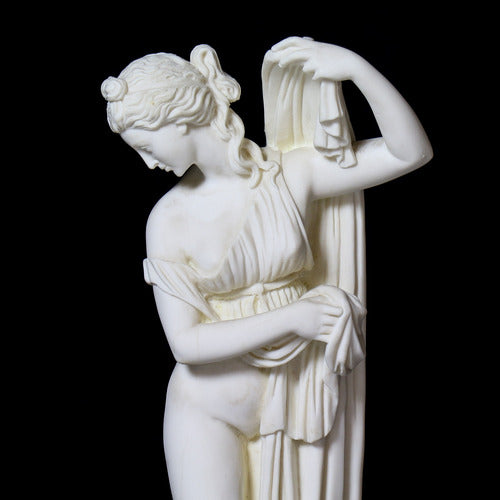 Classical Greek-style female statue in a graceful pose, featuring ornate drapery and elegant, old world European detailing. Side Angle