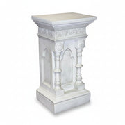 Ornate pedestal with classical Gothic arches, fluted columns, and intricate old world European detailing on the upper border.