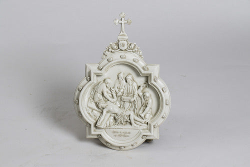 Baroque-style ornate wall plaque featuring a classical religious scene with intricate old world European detailing and a cross at the top.