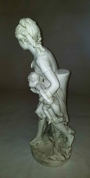 Classical European statue of a woman with two children, featuring ornate, old world detailing and Renaissance-inspired drapery. Side View