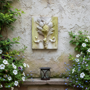 Ornate old world European wall plaque featuring a classical acanthus leaf and artichoke motif in a Baroque relief style. Side Angle