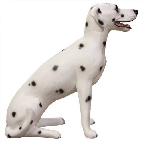 Dalmatian dog statue in a seated pose with classic black spots, sculpted in a naturalistic, old world European style. Side View