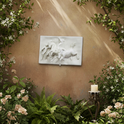 Classical bas-relief featuring a youth and two galloping horses in dynamic, ornate old world European style. Side Angle