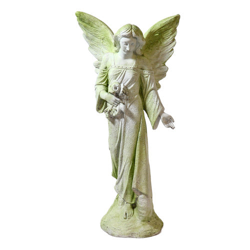 Standing angel with a serene expression, one hand extended and the other holding flowers, featuring large wings.