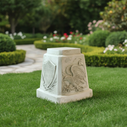 Pedestal with classical old world European style, featuring an ornate eagle relief and shield with laurel motif in bas-relief. Side Angle