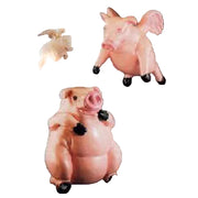 Flying pig figurines in whimsical, old world European style with ornate, exaggerated features and playful, rounded forms.