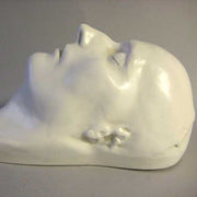 Classical European sculpted head with closed eyes, smooth features, and serene expression, evoking Renaissance and old world style. Other Angle