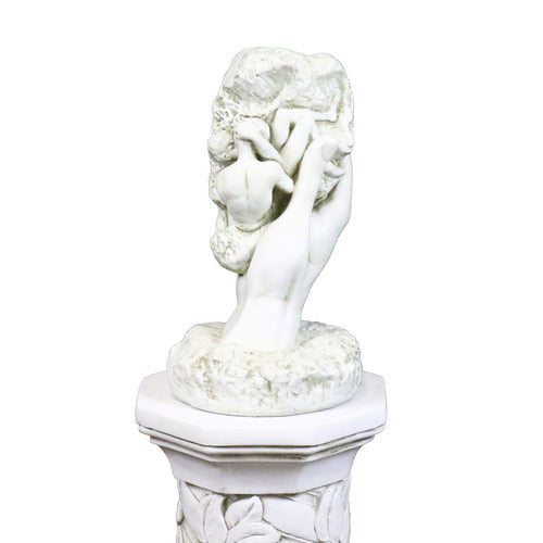 Classical sculpted hand emerging from ornate pedestal, holding a textured stone in old world European style Side View