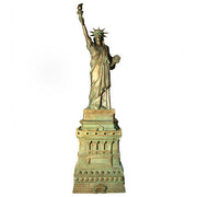Statue of Liberty replica with classical draped robe, ornate crown, and raised torch in neoclassical architectural style. Side View