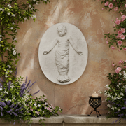 Classical bas-relief of a swaddled child with outstretched arms, featuring ornate old world European Renaissance style detailing. Side Angle