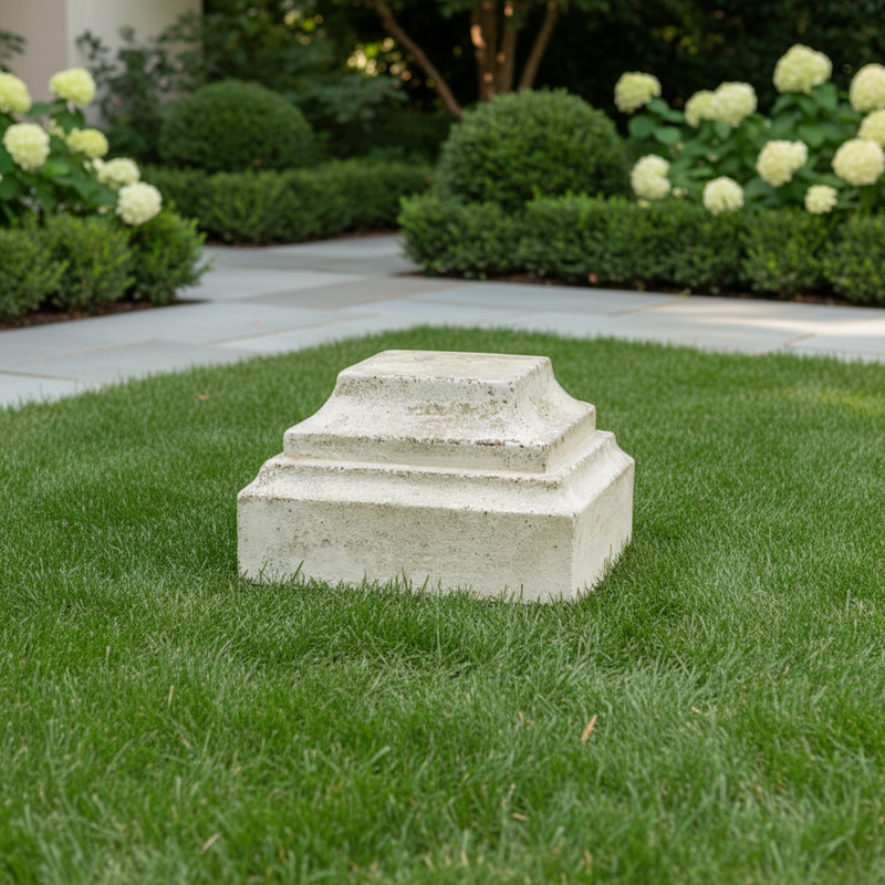 Classical pedestal base with stepped, tiered design and weathered old world European architectural style. Side Angle