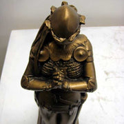 Kneeling medieval knight in ornate armor, hands clasped in prayer, classical old world European style with Gothic detailing. Additional Angle