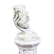 Classical sculpted hand emerging from ornate pedestal, holding a textured stone in old world European style Side Angle