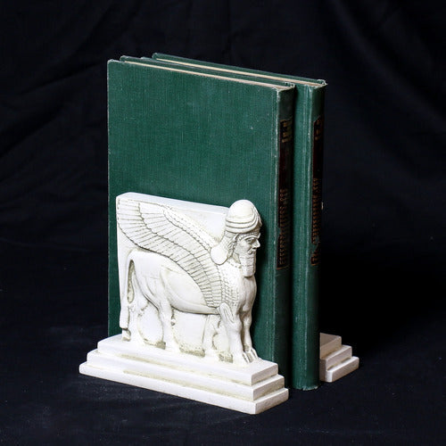 Sphinx-shaped ornate bookends with classical old world European detailing, supporting two upright hardcover books. Side View