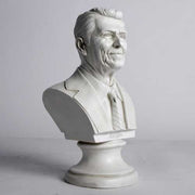 Classical-style bust of a distinguished man in a suit and tie with detailed facial features and an ornate pedestal base. Different Angle