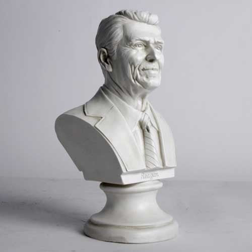 Classical-style bust of a distinguished man in a suit and tie with detailed facial features and an ornate pedestal base. Different Angle