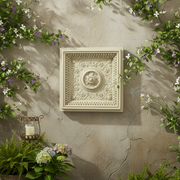 Ornate square wall panel with classical Baroque floral medallion and intricate old world European scrollwork border. Side Angle
