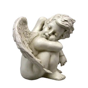 Sleeping cherub statue with detailed wings, curled pose, and classical old world European style, evoking Renaissance and Baroque themes.