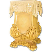 Ornate Baroque altar table with intricate scrollwork base, clawed feet, and classical lace cloth featuring Gothic cross motifs.