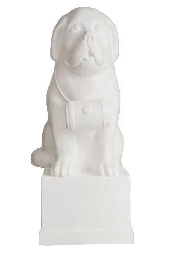 St. Bernard dog statue with barrel collar, seated on a pedestal in classical European style with subtle ornate detailing.