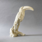 Toucan sculpture with ornate, old world European detailing and classical textured finish, perched on a stylized branch base. Side View