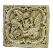 Medieval-style relief plaque depicting a winged dragon and a robed figure in ornate, old world European architectural framing.