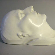 Classical European sculpted head with closed eyes, smooth features, and serene expression, evoking Renaissance and old world style. Different Angle