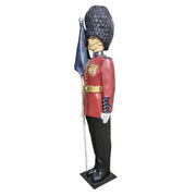 British royal guard statue in ornate old world European style uniform, tall bearskin hat, holding a flag, classical military theme Different Angle