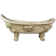 Ornate old world European clawfoot bathtub with classical Baroque floral reliefs and sculpted lion paw feet.