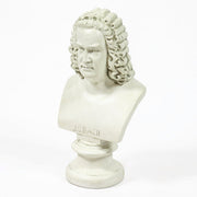 Classical European bust with ornate, curly hair in old world style, displayed on a pedestal with Renaissance-inspired detailing. Different Angle