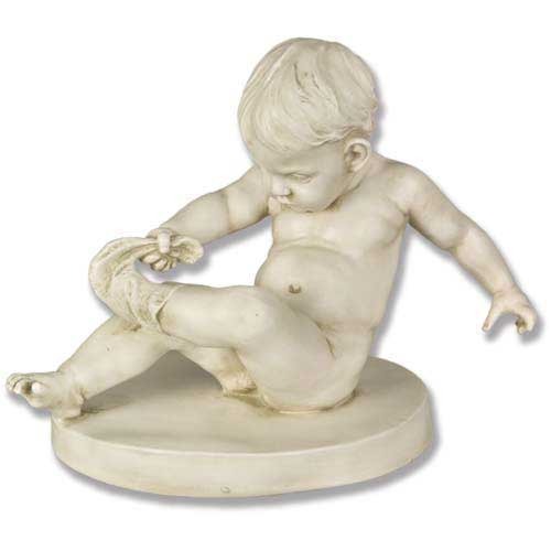 Classical Renaissance-style cherub sculpture seated on a round base, depicted playfully holding its foot with detailed, ornate features.
