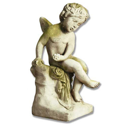 Seated cherub Statue with small wings holding a flower on a rock base.