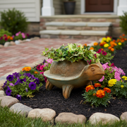 Turtle-shaped planter with ornate, old world European detailing and Renaissance-inspired sculptural features, filled with lush greenery. Side Angle