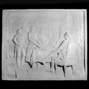 Classical bas-relief panel depicting a group of men in ornate 18th-century attire gathered around a table in a stately interior. Side View