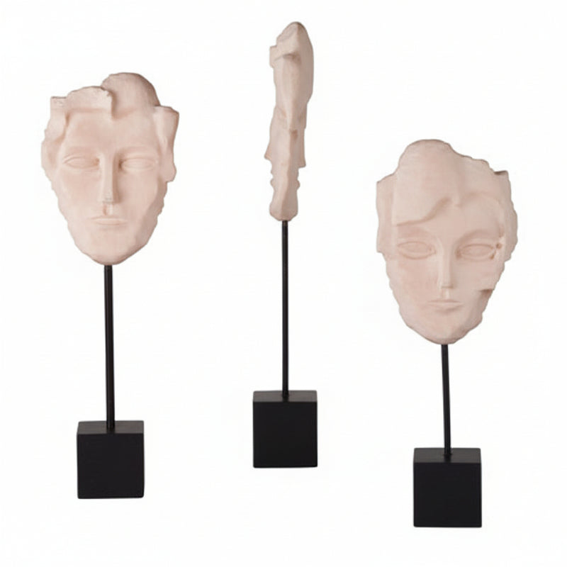 Fragmented classical face sculptures on black stands, featuring old world European and Renaissance-inspired ornate detailing.