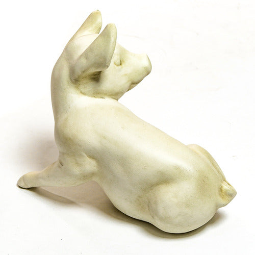 Seated pig figurine with gentle expression, sculpted in an old world European classical style with smooth, ornate detailing. Different Angle
