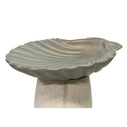 Shell-shaped dish with ornate, old world European design and classical scalloped detailing, resting on a pedestal base.