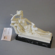 Reclining classical female figure in Greco-Roman style with ornate detailing, resting on a dark rectangular base. Side Angle